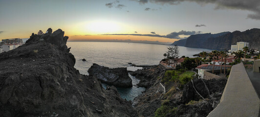 sunset on the calm coast of Los Gigantes cliff