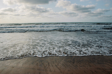 Fototapeta na wymiar Sea waves with white foam in the Ocean. place El Jadida Morocco. Summer 2023