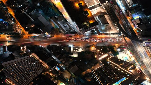 Night city lights drone time lapse at Bangkok, Thailand.
Flying along the highway road with moving traffic with DJI Mavic. Modern skyscrapers, buldings, blocks around, hyperlapse, abstract