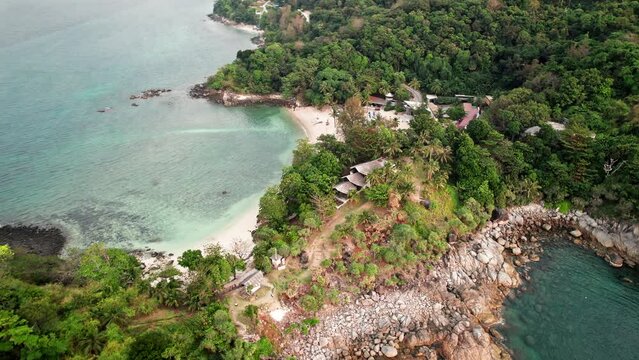 Drone flight near coastline view at Phuket, Thailand. Amazing rocky cape shore surrounded by Andaman sea waves.