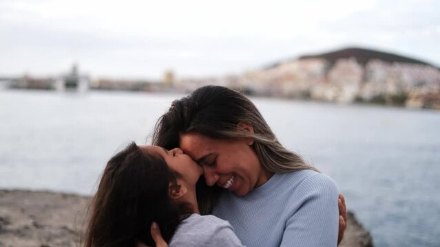 4k video of Mother and daughter giving lots of tender hugs and kisses. Concept: happiness, motherhood, education