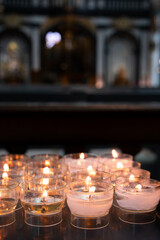 Burning candles in church, selective focus