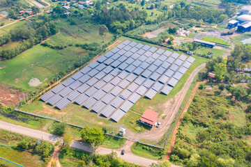 Aerial view of solar panels or solar cells on the roof of factory building rooftop. Power plant, renewable clean energy source. Eco technology for electric power in industry.
