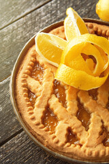 Delicious lemon pie, tart  with cooking ingredients on the wooden table