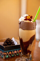 Colombian coffee smoothie with whipped cream and decorated with a flower
