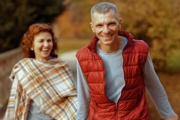 happy modern boyfriend and girlfriend in park walking