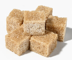 Cane sugar cubes on white background