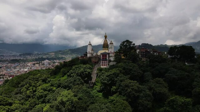 Aerial view of the popular Tibetan pilgrimage temple Swayambhu in Kathmandu valley in Nepal. Drone flight with a view of Swayambhunath. Cinematic 4k footage.