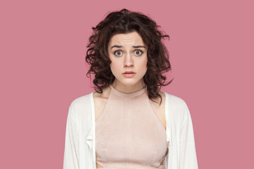Portrait of surprised shocked sad attractive woman with curly hair wearing casual style outfit...
