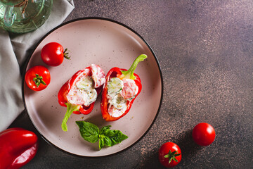 Fresh bell pepper stuffed with cucumber, tomato and greek yogurt on a plate top view