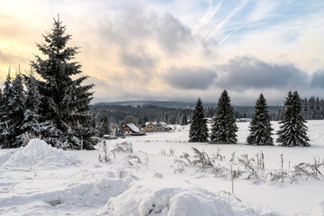 Winter and snow at Filipova Hut, Sumava national park, trees and colorful sky