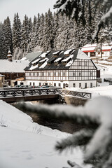 Winter Modrava and old historical building with wooden bridge, Sumava mountains