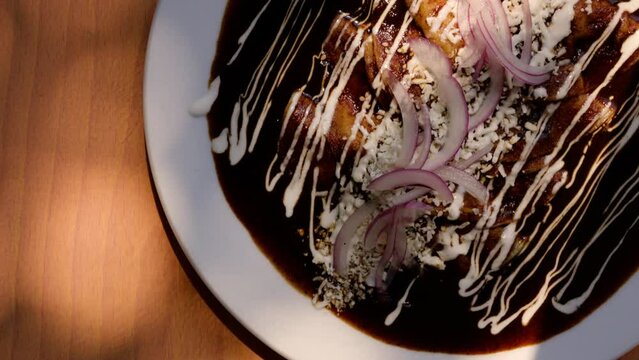 Las enmoladas con un platillo mexicano que representa su cocina. Son tortilla rellenas de carne, huevo &oacute; queso, ba&ntilde;adas en el delicioso y tradicional mole mexicano.