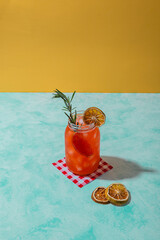 refreshing summer red orange drink on reused jar