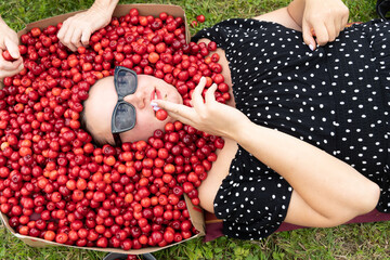 Backstage shooting of a young woman with cherries
