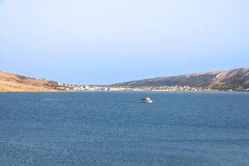 Beautiful seascapes on the island of Pag in Croatia, sandy mountains and hills in the blue sea