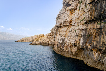 Aerial view of sea waves and fantastic rocky shore, photo with seascape for background. Clear sea water in the mountains