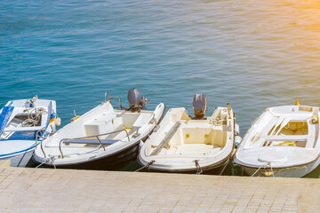 Motor boats are moored at the pier. Blue ocean