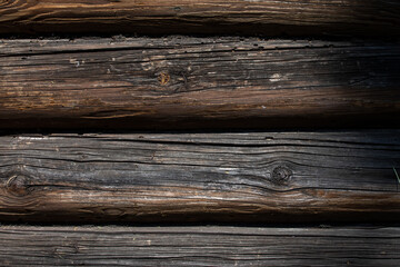 Fototapeta premium Wooden logs of an old house. The background is made of natural wood.