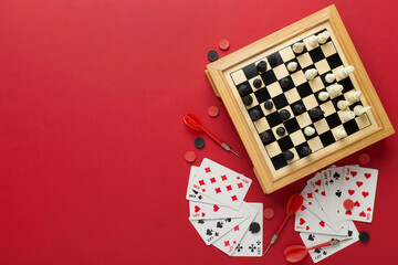 Different board games on color background, top view