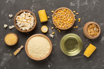 Maize products with fresh corn cobs on concrete background, top view