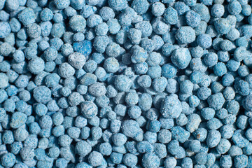 Background blue granules. Blue granular fertilizer for plants.