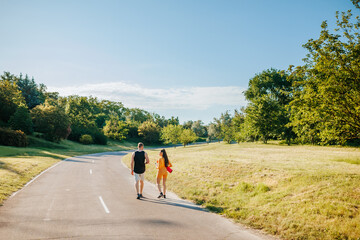 Obraz premium Capturing Togetherness Back View of Two Athletes Walking Outdoors and Chatting After Training, Back View of Two Athletes Talking Outdoors After Training