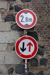 Foto op Plexiglas Navigating History: Road Signs Governing Passage at the Historic Rheintor in Zons, Setting Vehicle Limit at 2.8m during Zons Stadtfest's 650th Anniversary Celebration . Typical German street signs . © Sophia