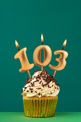 Birthday card with candle number 103 - Green background