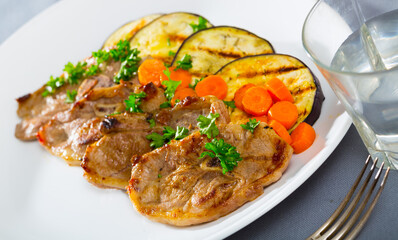 Delicious slices of roasted lamb meat served with grilled eggplant, carrot and herbs