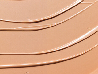 Makeup Liquid foundation composition background. BB CC Cream Concealer texture. Cosmetic product brush swatch