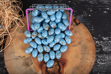 Heap of sugared almonds and hazelnuts dragees in chocolate isolated on dark background. Handmade...