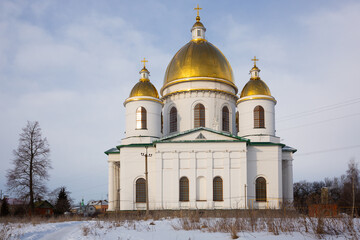 Fototapeta na wymiar Majestic building of Trinity Cathedral with golden domes in Russian town of Morshansk on winter day.