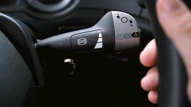 The truck driver switches the retard control lever. Close-up.