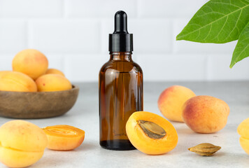 Apricot oil and fresh apricots in a brown bottle. Natural cosmetic. 