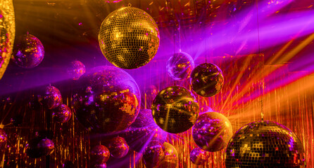 disco background with golden and purple rays of mirror balls
