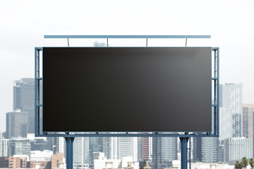 Blank black billboard on city buildings background, front view. Mockup, advertising concept