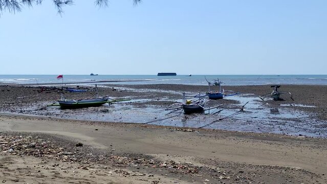 north coast of java which is used as a berth for wooden fishing boats close to the Paiton steam power plant, Probolinggo, East Java, Indonesia