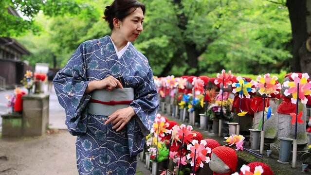 Japanese woman in a kimono admiring traditional shrine in Tokyo, Japanese ethnicity, cultural and ethnic diversity concept