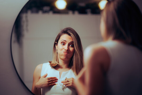 Funny Girl Looking the Mirror Wiping Her Dress. Unlucky woman having an accident with coffee stains
