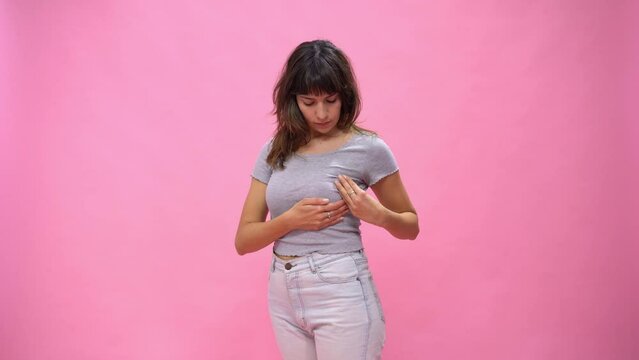 Woman doing a Breast Self-Exam (BSE). Copy-space.