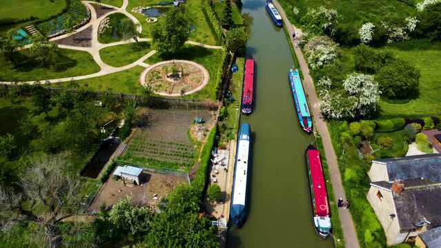 Bustling grand union canal in stoke bruerne, aerial dolly bird's eye view