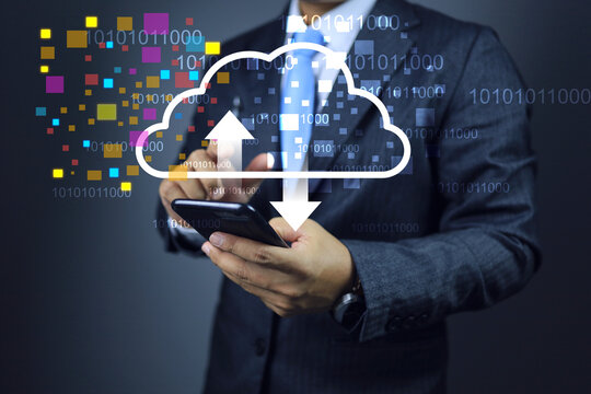 Businessman using smart phone to download and upload data into cloud computing, binary numbers floating around showing data access anywhere with high speed internet signal. Data transformation concept