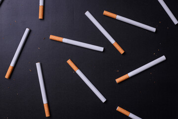 Abstract composition of flat lay cigarettes on black background. World no tobacco day and no smoking concept.