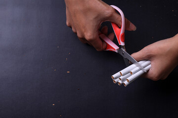 Close up of scissors cutting many cigarettes. Concept of anti smoking, stop smoking and no tobacco day