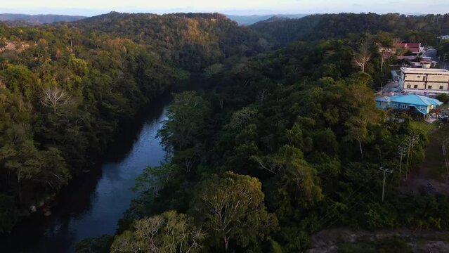 Aerial over the Macal River near San Ignacio in Belize. Drone dolly forward shot