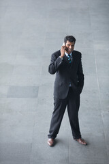 Above view of an Indian businessman using his Smart phone.