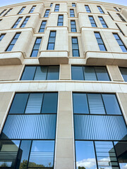 new modern office building with blue windows glass. closeup bottom view.