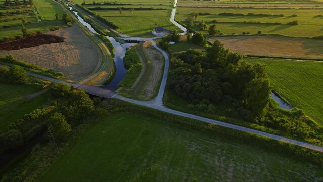 Aerial orbiting shot of a bridge and a river in Polish nature reserve Beka.