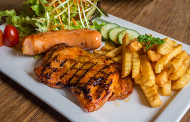 chicken steak and sausage with side dish